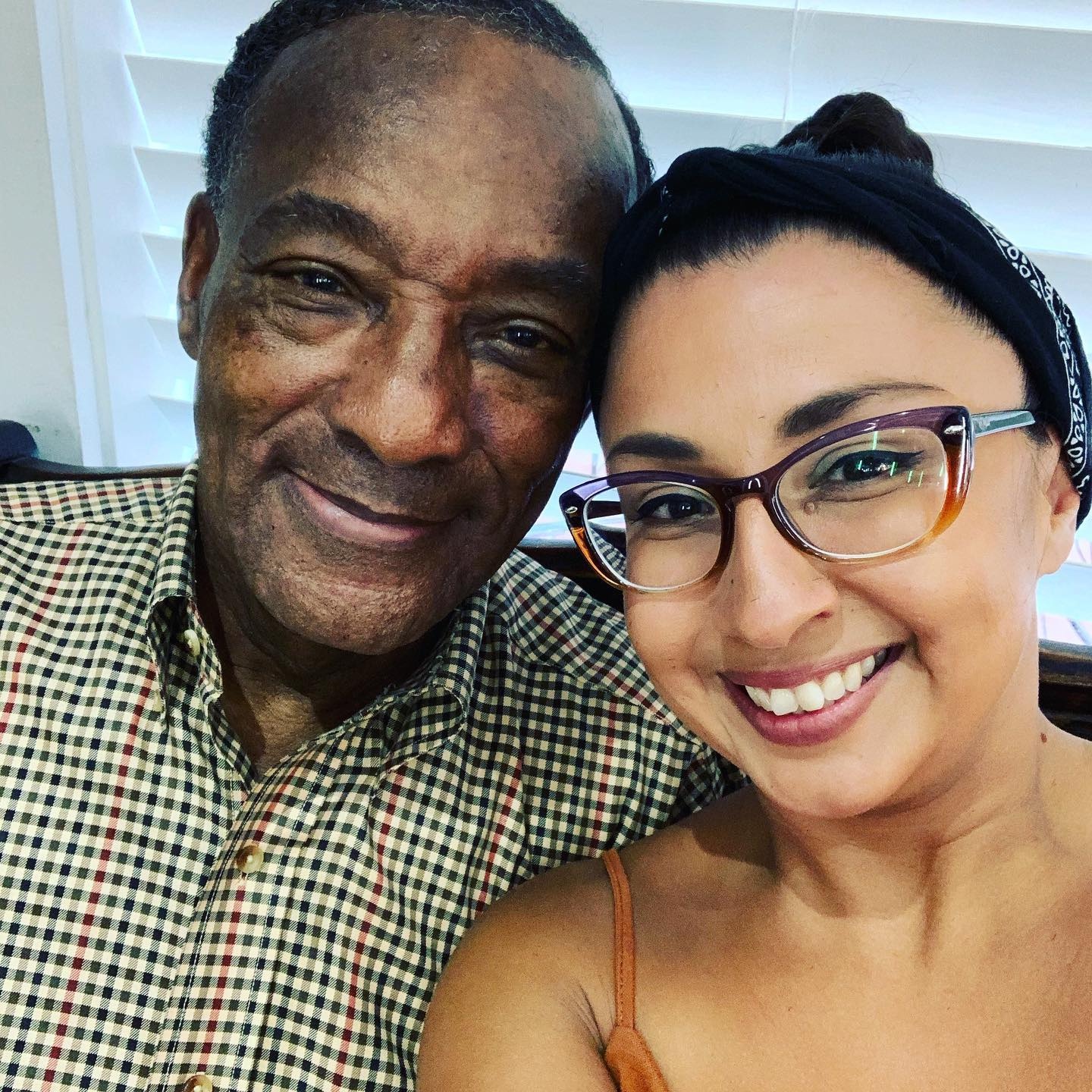 Two people smiling together in a candid selfie